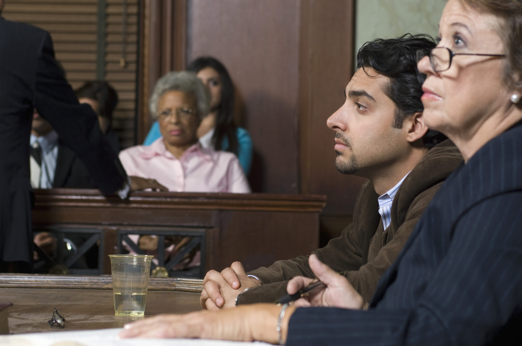 Lawyers in court room discussing domestic abuse case