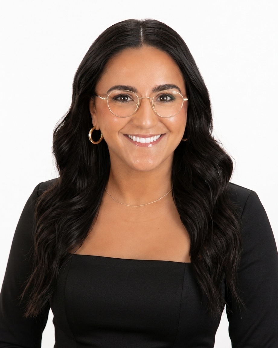 Smiling woman in glasses wearing black outfit