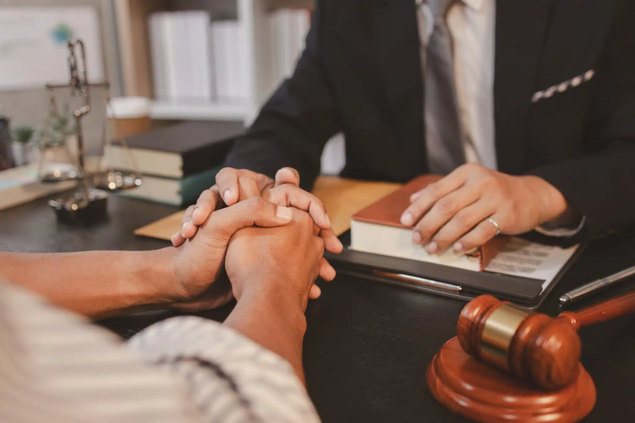 Client consulting lawyer with gavel on desk