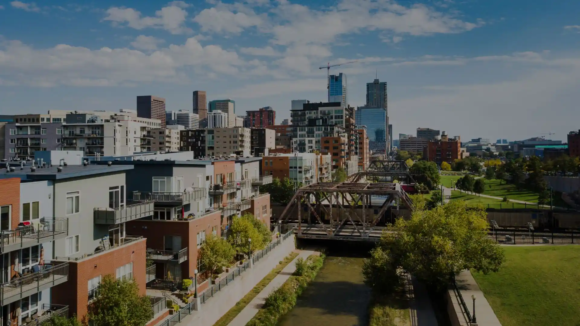 Modern city skyline with river and railway bridge in Aurora colorado
