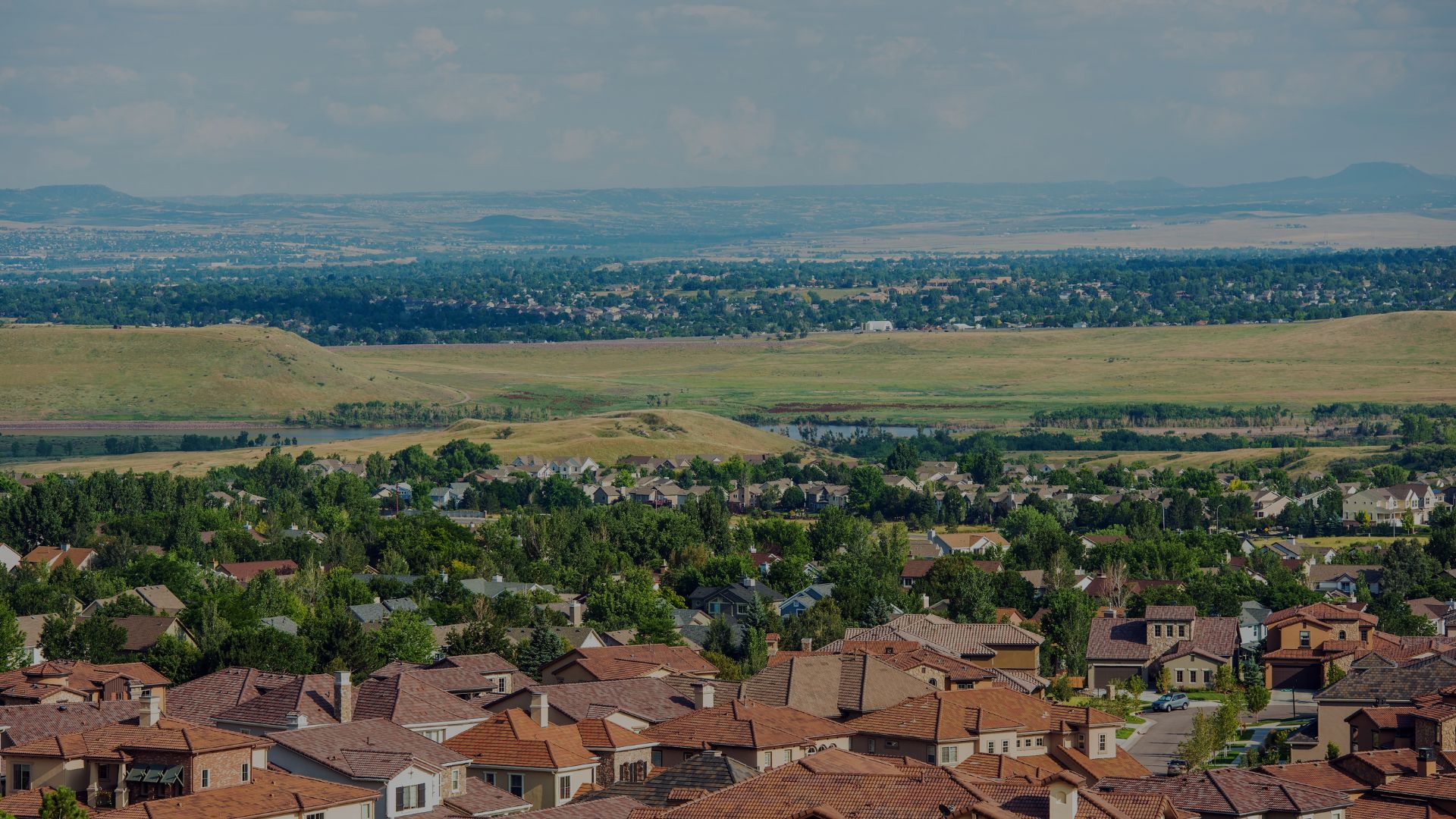 Suburban neighborhood with red roofs and rolling hills in lakewood colorado
