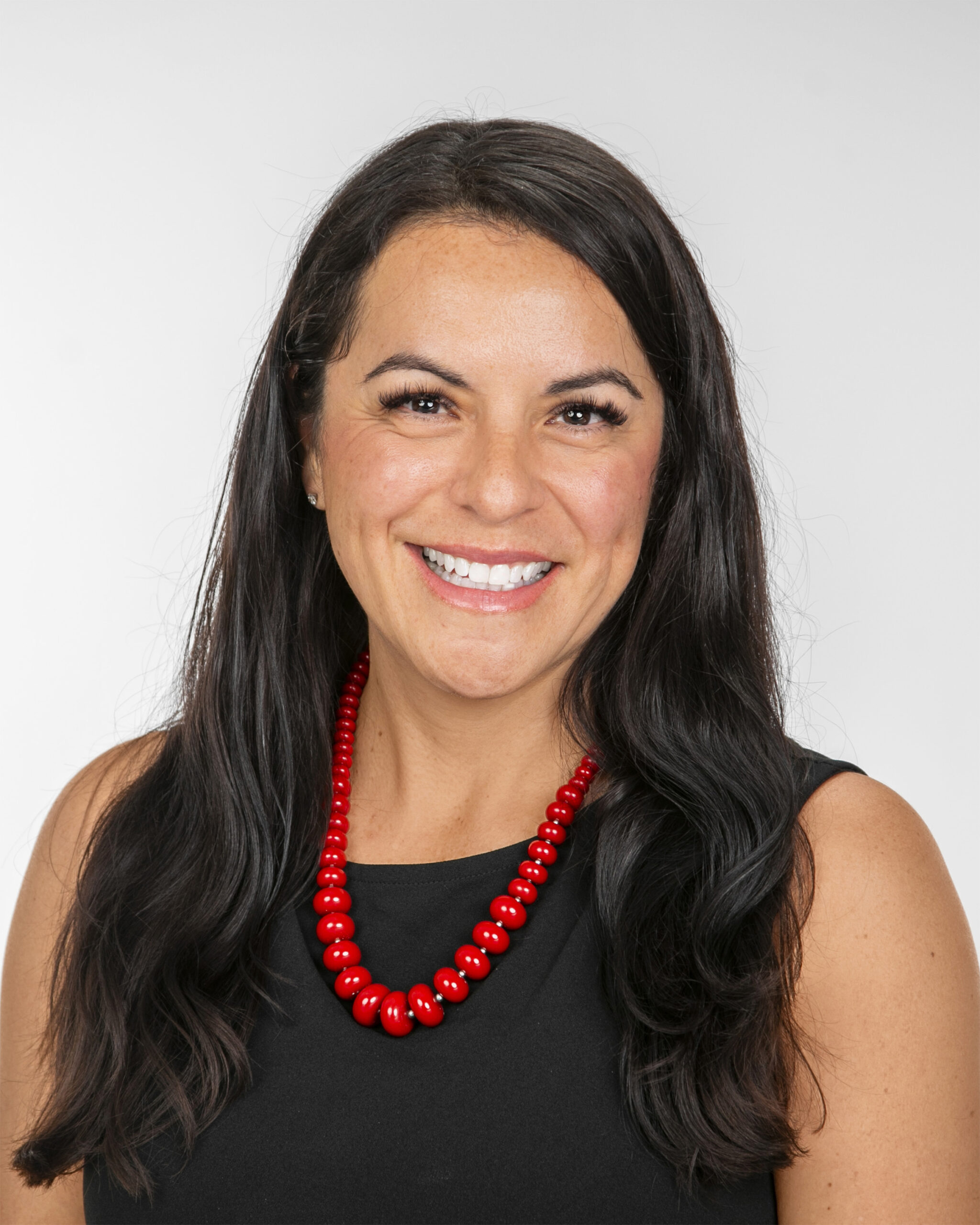 Smiling woman wearing a red beaded necklace