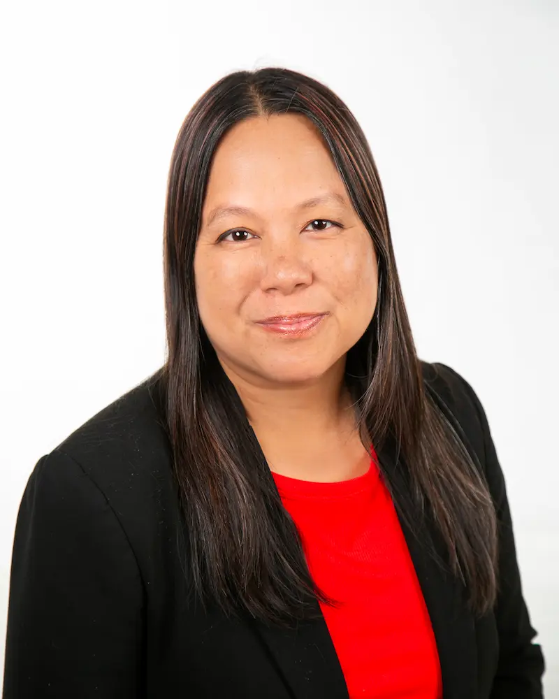 Professional headshot of woman in black blazer