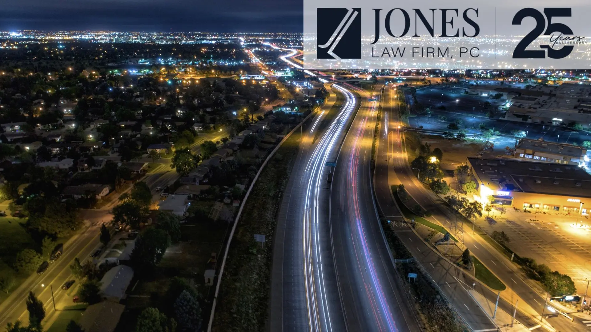 Aerial night highway with city lights and logo