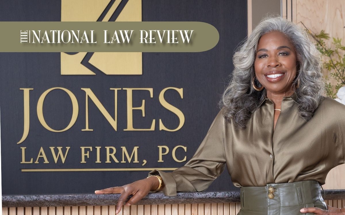 Attorney standing beside Jones Law Firm sign