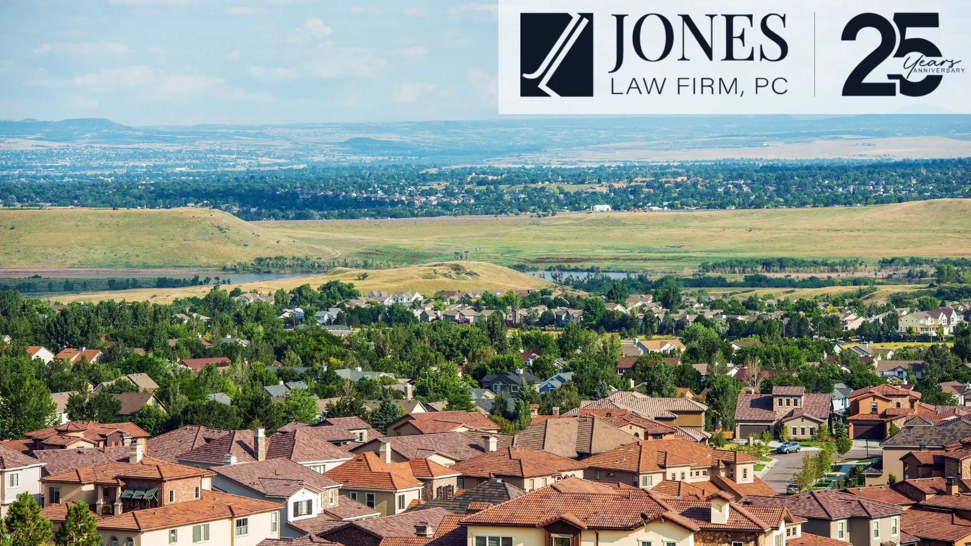 Suburban neighborhood with hills and Jones Law Firm banner