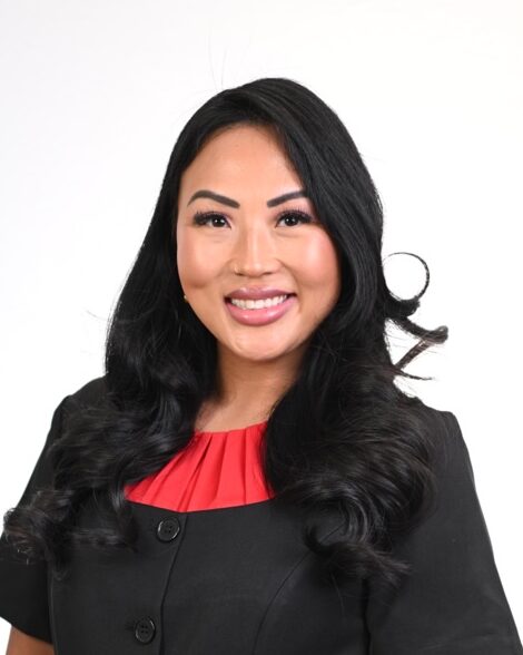 Smiling woman in black blazer and red blouse