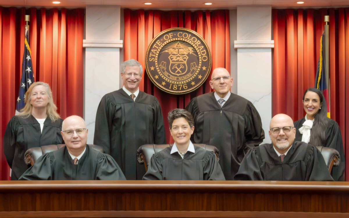 Colorado Supreme Court justices posed beneath state seal